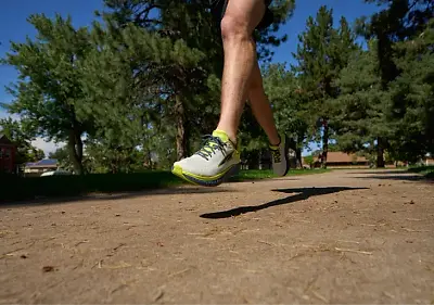 Person running in a pair of Altra Torin 7 running Greens