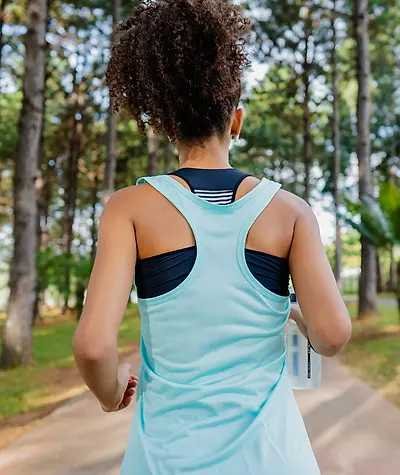 Close up of the back of a woman's tank top as she runs.