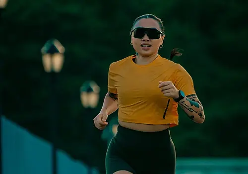 woman in pyrns crop top running