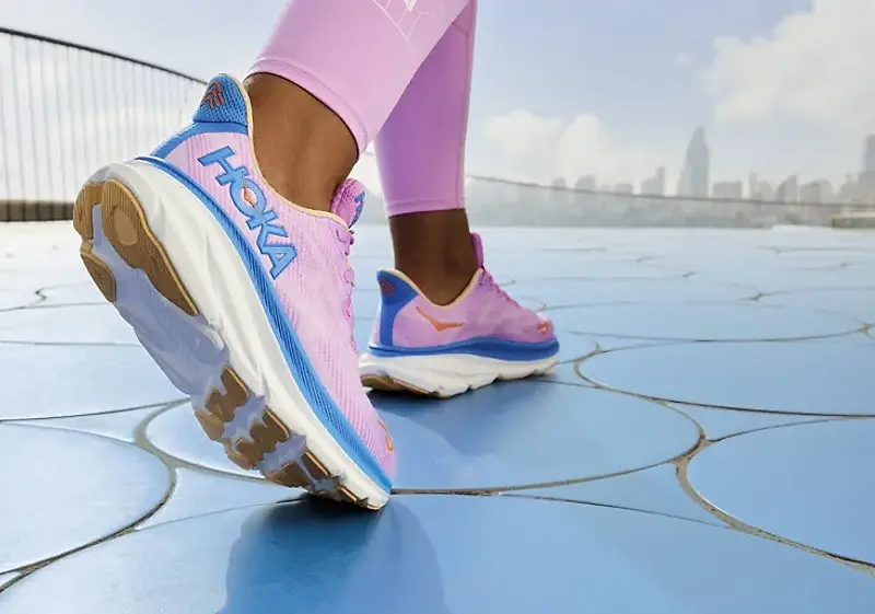 woman wearing the hoka clifton 9 in pink