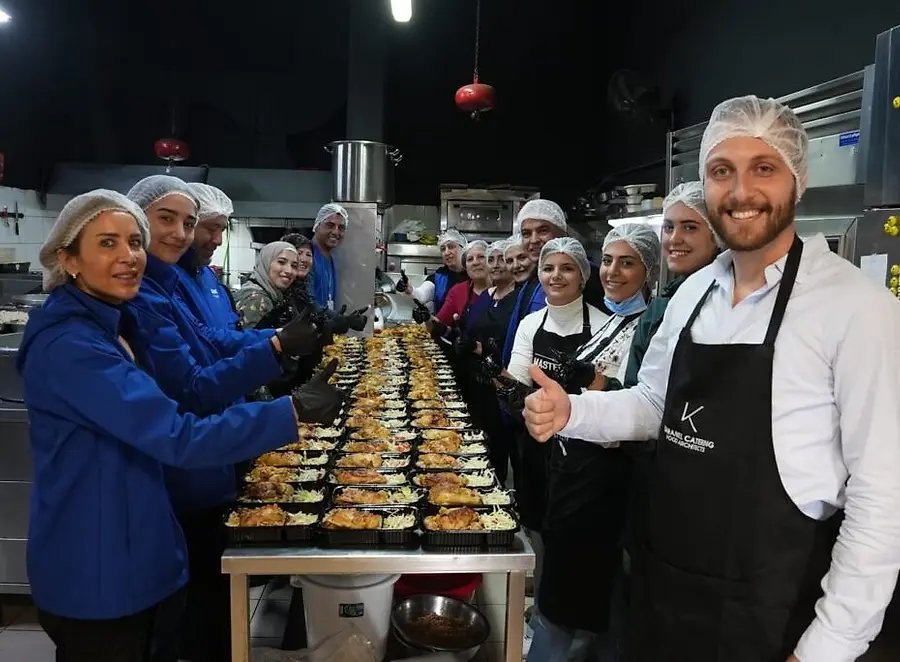 Lebanon of Tomorrow Cooperative Members pose around the food they've prepared